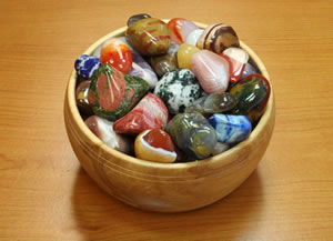 wooden bowl of tumbled stones